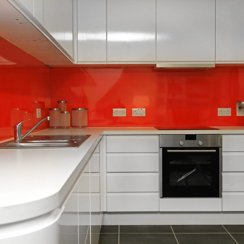 Modern kitchen counter with red backsplash