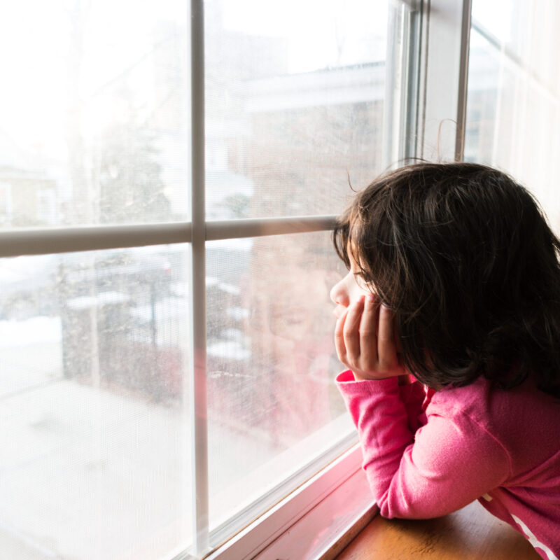 little girl looking out the window